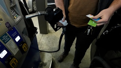 A customer prepares to pump gasoline into his car at a Sam's Club in Gulfport, Miss., Feb. 19, 2022.