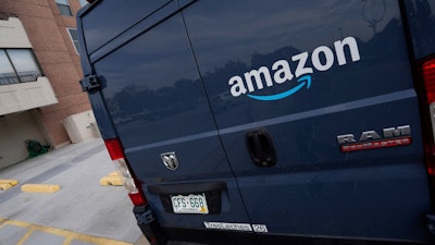 The company logo graces one of the doors of a delivery van for Amazon Wednesday, Sept. 1, 2021, in Denver. Amazon said Wednesday, April 13, 2022 it will add a 5% “fuel and inflation surcharge” to fees it charges third-party sellers who use the retailer’s fulfillment services as the company faces rising costs. The company said in an announcement on its website that the added fees will take effect on April 28 and are subject to change. Federal data released Tuesday showed inflation hit 8.5% in March, its fastest pace in more than 40 years.