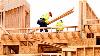 Construction workers build new homes in Philadelphia, Tuesday, April 5, 2022. Low mortgage rates have helped juice the housing market over the past decade, easing the way for borrowers to finance ever-higher home prices. A run-up in rates in recent weeks is threatening to undo that dynamic, setting the stage for a slowdown in home sales this year as the increased borrowing costs reduce would-be buyers’ purchasing power.