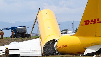 A cargo jet that spun off lays broken on the runway of the Juan Santamaria International Airport in Alajuela, Costa Rica, Thursday, April 7, 2022. According to the fire department, both the pilot and the co-pilot are reported in good health, and accident caused the total closure of the air terminal.