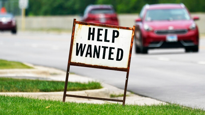 A help wanted sign is displayed at a gas station in Mount Prospect, Ill., Tuesday, July 27, 2021. Fewer Americans applied for unemployment benefits last week as layoffs remain at historically low levels. Jobless claims fell by 5,000 to 166,000 for the week ending April 2, 2022 the Labor Department reported Thursday.