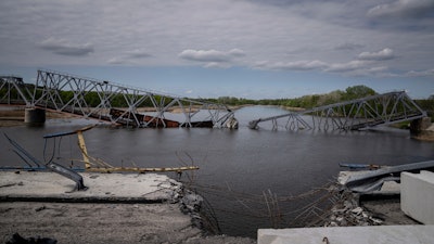 A destroyed railway bridge over the Siverskiy Donets river near Raigorodka, Ukraine, April 30, 2022.