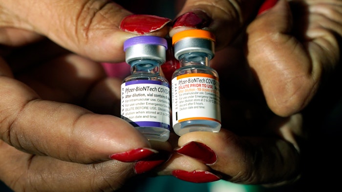 A nurse holds a vial of the Pfizer COVID-19 vaccine for children ages 5 to 11, right, and a vial of the vaccine for adults, which has a different colored label, at a vaccination station in Jackson, Miss., Tuesday, Feb. 8, 2022. U.S. regulators authorized a COVID-19 booster shot for healthy 5- to 11-year-olds on Tuesday, May 17, 2022, hoping an extra vaccine dose will enhance their protection as infections once again are on the rise.