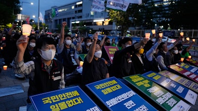 Members of the Public Service and Transport Workers Union rally to support an ongoing trucker strike outside the presidential office in Seoul, June 14, 2022.