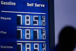 High gas prices are shown as a pedestrian waits to cross the street in Los Angeles, June 16, 2022. President Joe Biden on June 22 will call on Congress to suspend the federal gasoline and diesel taxes for three months. It's a move meant to ease financial pressures at the pump that also reveals the political toxicity of high gas prices in an election year.