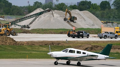 A small plane taxis past construction at the Des Moines International Airport, Des Moines, Iowa, June 13, 2022.