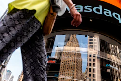 People walk past the Nasdaq MarketSite, New York, July 13, 2022.