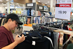 A customer checks price tags while shopping at a store in Schaumburg, Ill., June 30, 2022.