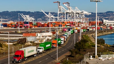 Trucks line up to enter a shipping terminal at the Port of Oakland, Oakland, Calif., Nov. 10, 2021.