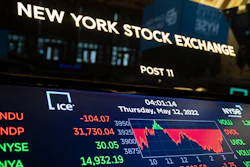 Screens display end-of-day trading results at the New York Stock Exchange on May 12, 2022, in New York.