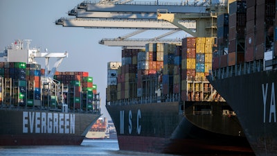 Container ship Ever Far, left, sails past the Port of Savannah, Ga., Sept. 29, 2021.