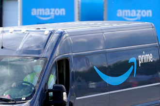 A delivery van departs an Amazon Warehouse in Dedham, Mass., Oct. 1, 2020.