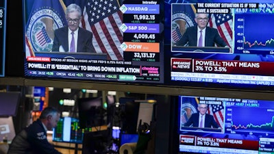 A news conference held by Federal Reserve Chair Jerome Powell is watched at the New York Stock Exchange, July 27, 2022.