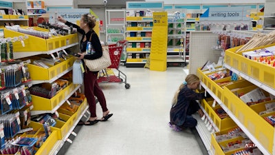 A parent shops for school supplies deals at a Target store, July 27, 2022, North Miami, Fla.
