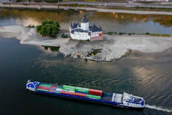 A container ships passes Pfalzgrafenstein castle in the middle of the river Rhine in Kaub, Germany, Friday, Aug. 12, 2022. The Rhine carries low water after a long drought period.