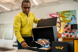 Shekar Natarajan, chief supply chain officer at American Eagle Outfitters, demonstrates the 'Tag Along' shipping box system in New York, Aug. 5, 2022.