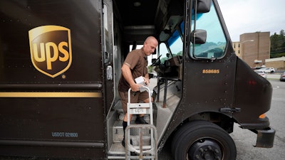 UPS driver Joe Speeler makes a delivery at the Leanon Shops in Mount Lebanon, Pa., Sept. 21, 2021.