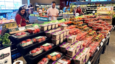 People shop at a grocery store in Glenview, Ill., July 4, 2022.
