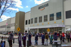 In this image from video, Amazon workers line up outside the company's facility in Staten Island, New York, March 25, 2022.