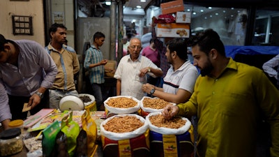 Retailers shop for dry fruits in a wholesale market, New Delhi, Oct. 10, 2022.