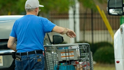 A shopper removes purchases from his cart in Jackson, Miss., Oct. 12, 2022.