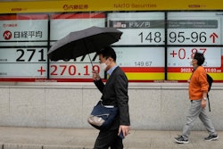 Monitors show the Nikkei 225 index and the yen's exchange rate against the U.S. dollar, Tokyo, Oct. 24, 2022.