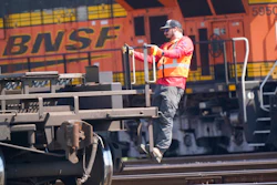 A worker rides a rail car at a BNSF rail crossing in Saginaw, Texas, Wednesday, Sept. 14, 2022. Most railroad workers weren't surprised that Congress intervened this week to block a railroad strike, but they were disappointed because they say the deals lawmakers imposed didn't do enough to address their quality of life concerns about demanding schedules and the lack of paid sick time.