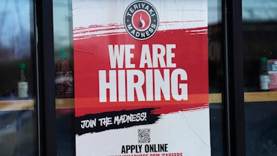 A hiring sign displayed at a restaurant in Rolling Meadows, Ill., Jan. 30, 2023.