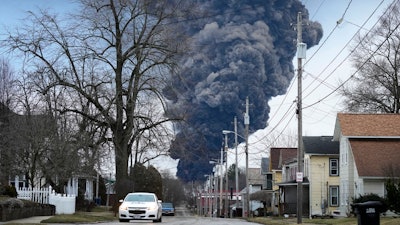 A black plume rises over East Palestine, Ohio, after a controlled detonation of derailed Norfolk Southern trains, Feb. 6, 2023.