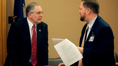 Kansas Sen. Mike Thompson, R-Shawnee, confers with Jason Long, an attorney on the Legislature's bill drafting staff, before a committee meeting at the Statehouse in Topeka, March 7, 2023.