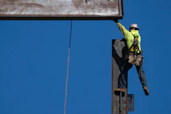 An ironworker guides a beam during construction of a municipal building in Norristown, Pa., Feb. 15, 2023.