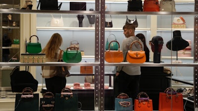 Bags displayed in the window of a Kate Spade store in Pittsburgh, Jan. 30, 2023.