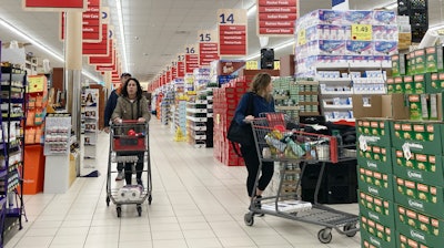 People shop at a grocery store in Buffalo Grove, Ill., March 19, 2023.