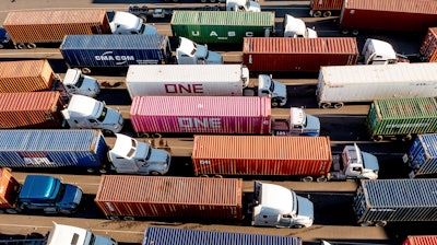 Trucks line up to enter a Port of Oakland shipping terminal, Nov. 10, 2021, Oakland, Calif.