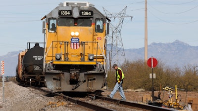 The crew on a Union Pacific freight train works at a siding area south of Tucson, Ariz., Jan. 24, 2020.