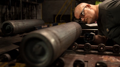 A steel worker inspects a 155 mm M795 artillery projectile at the Scranton Army Ammunition Plant, Scranton, Pa., April 13, 2023.