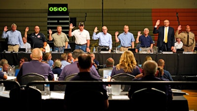 Witnesses are sworn in during a National Transportation Safety Board investigative hearing at East Palestine High School, East Palestine, Ohio, June 22, 2023.