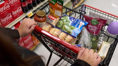 A shopper pushes a cart of groceries at a supermarket in Bellflower, Calif., Feb. 13, 2023.