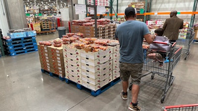 Shoppers peruse Rainer cherries at a Costco warehouse in Sheridan, Colo., July 11, 2023.