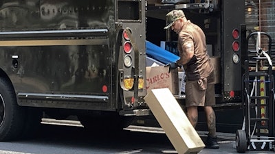 A UPS driver sorts deliveries on New York's Upper West Side, July 15, 2023.