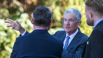 Federal Reserve Chair Jerome Powell talks with attendees of the central bank's annual symposium, Jackson Lake Lodge, Grand Teton National Park, Moran, Wyo., Aug. 26, 2022.