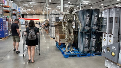 Shoppers pass a display of Halloween goods in a Costco warehouse, Thornton, Colo., Aug. 4, 2023.