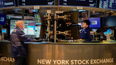 Traders work at their stations at the New York Stock Exchange, May 26, 2023.