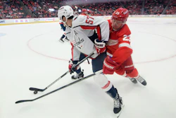 Detroit's Lucas Raymond tries to steal the puck from Washington's Trevor van Riemsdyk a Capitals-Red Wings preseason game, Detroit, Sept. 30, 2023.