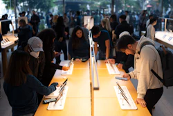 People look at Apple's new iPhone 15 at an Apple Store at The Grove, Los Angeles, Sept. 22, 2023.
