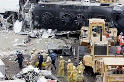 Emergency responders remove a body from the Metrolink commuter train that collided with a Union Pacific freight train the day before in Chatsworth, Calif., Sept. 13, 2008.