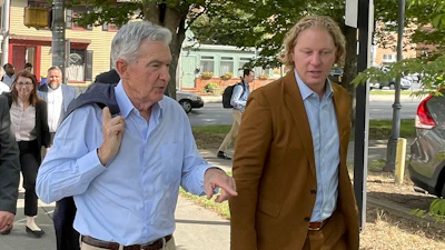 Federal Reserve Chair Jerome Powell, left, and Kevin Schreiber, CEO of the York County Economic Alliance, walk in York, Pa. on Monday, Oct. 2, 2023. Powell met with workers, employers and community leaders in York regarding efforts to strengthen the local economy.