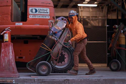 Construction workers move equipment on Jan. 17, 2023, in New York. On Tuesday, the Labor Department reports on job openings and labor turnover for August.