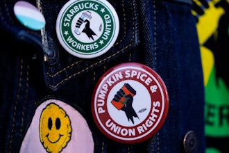 Union pins on a worker's jacket during a walkout at Starbucks' Reserve roastery, Seattle, Nov. 16, 2023.
