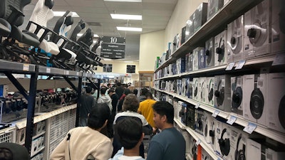 Patrons stand in line at a Micro Center store in Yetta, Ga., Nov. 24, 2023.